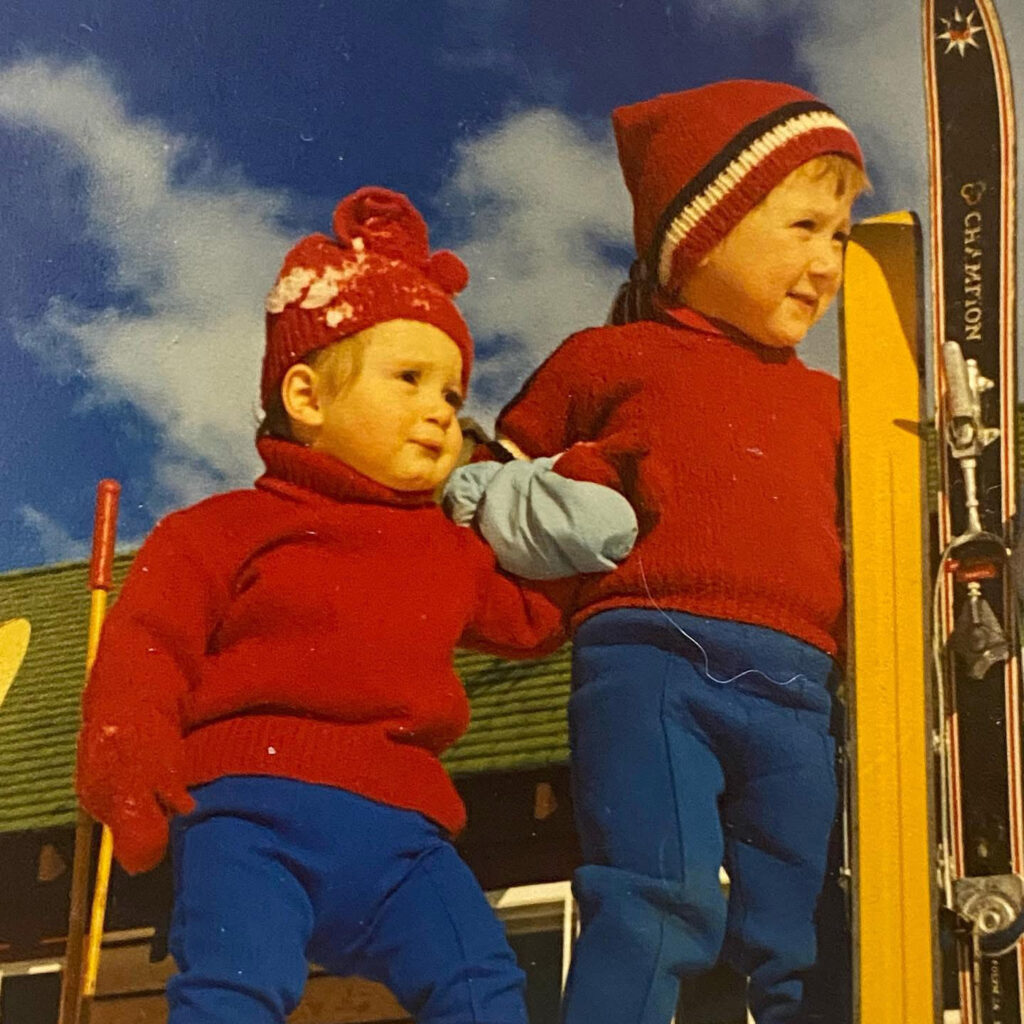 Two young children in matching red sweaters at Mount Norquay ski resort, 1970s.